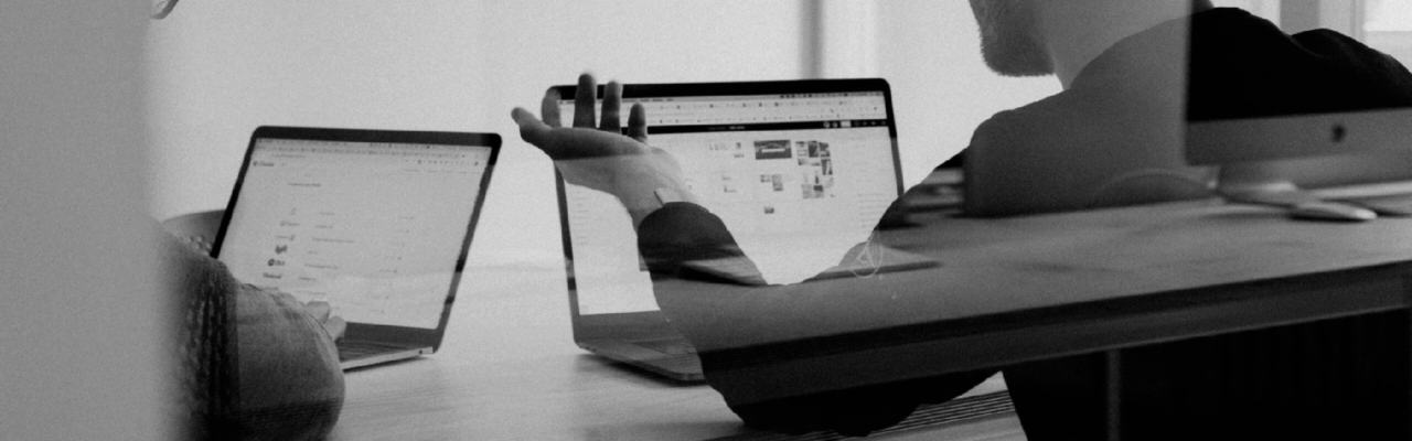 Determining The True Costs Of Not Tracking Business Travel Spending 9 Two work mates reunited with their laptops and talking about work