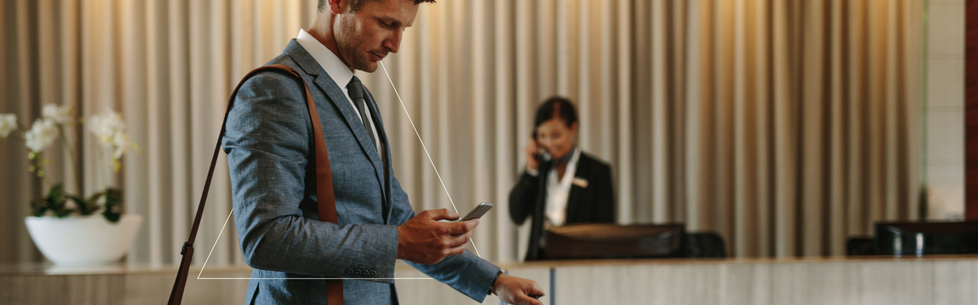 Hotel sourcing. Man in hotel reception.