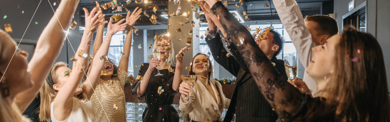Friends celebrating, smiling and cheering in an event. Top event trends for 2026 post cover image.