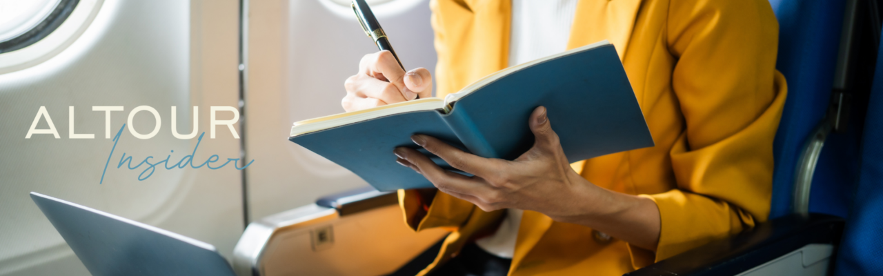 December Newsletter 11 woman on an airplane taking notes in a notebook. Newsletter cover image